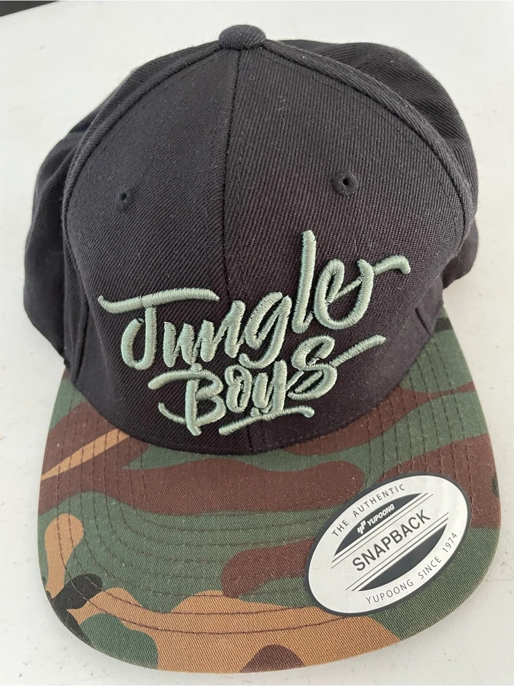 Mens Stylish Jungle Boys Logo Snapback Cap - Black with Camouflage Brim.